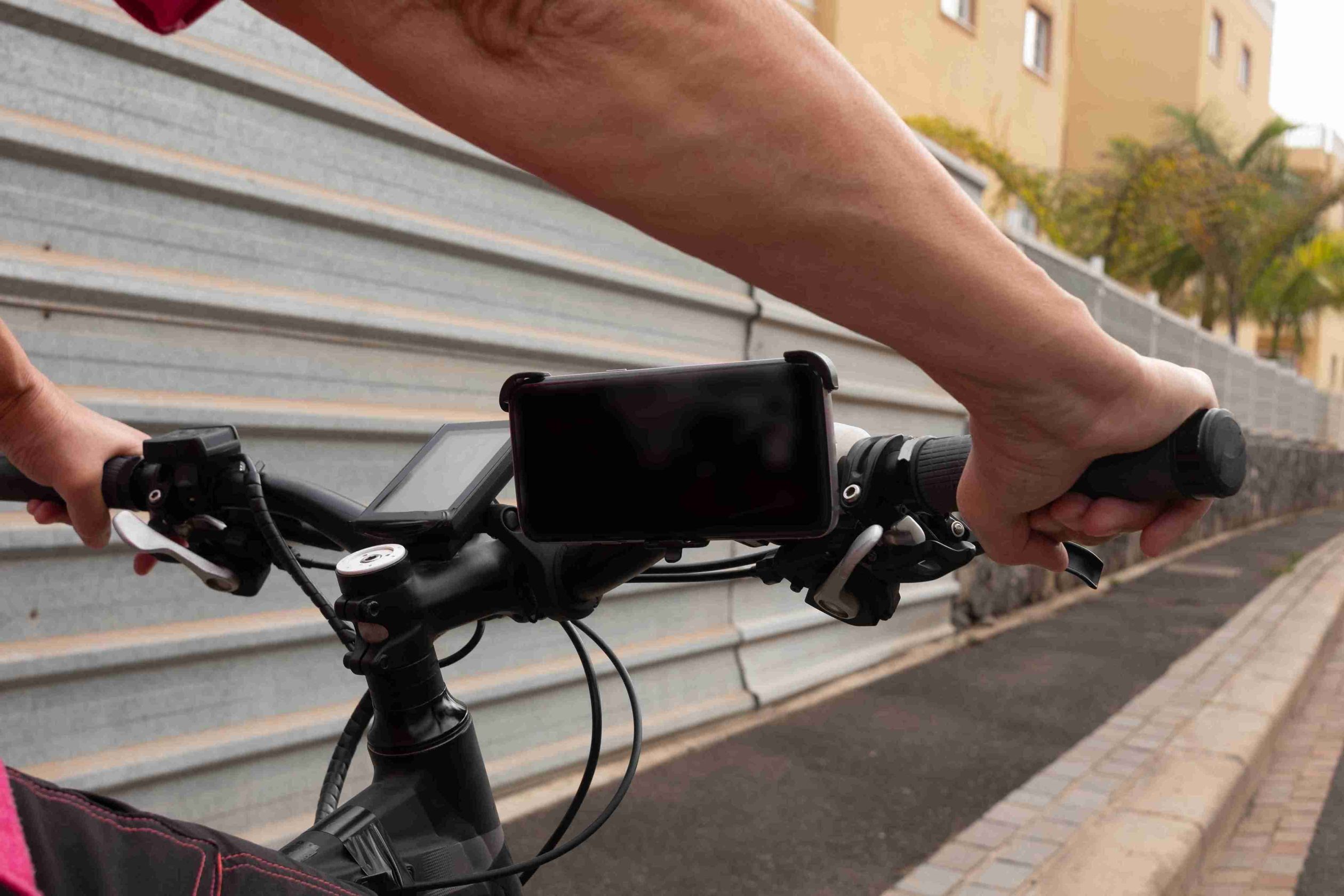 view-devices-electric-bicycle-handlebar-with-two-female-hands-outdoor-street-sunset-light-tropical-place_