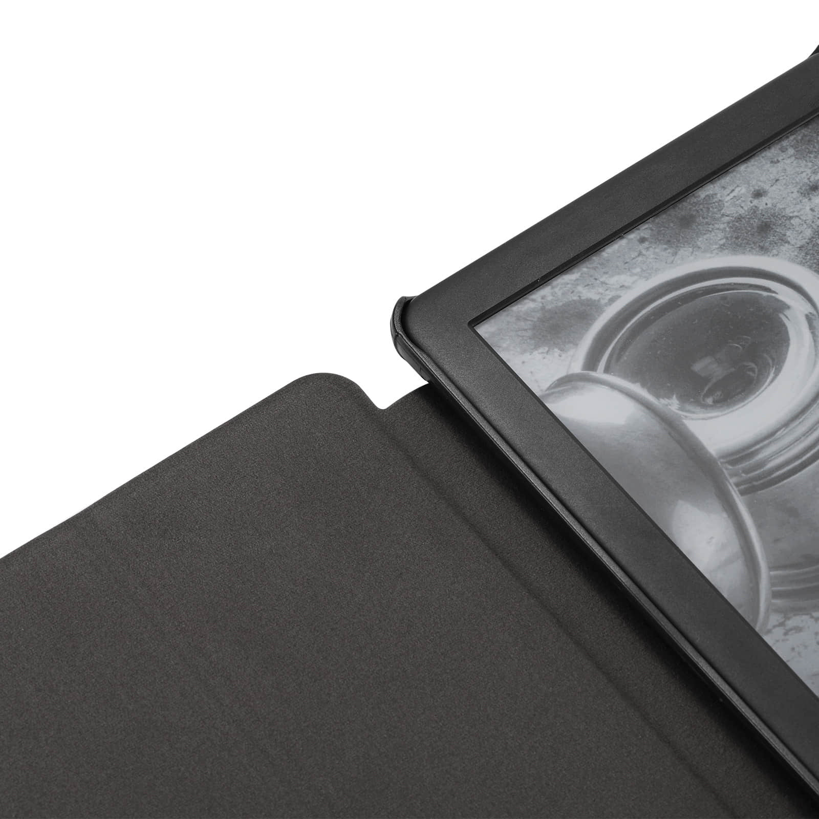 Close-up of a black folding leather case corner fitted on a gray e-ink tablet device