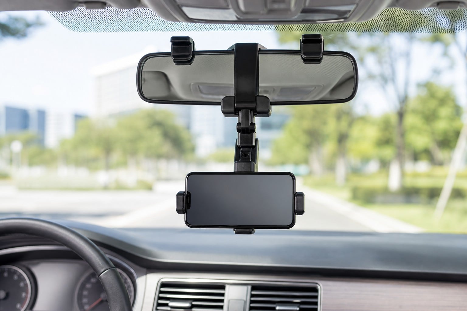 Rearview mirror phone holder mounted in a modern car interior